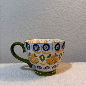 Floral Patterned Ceramic Mug with Green Handle Designer